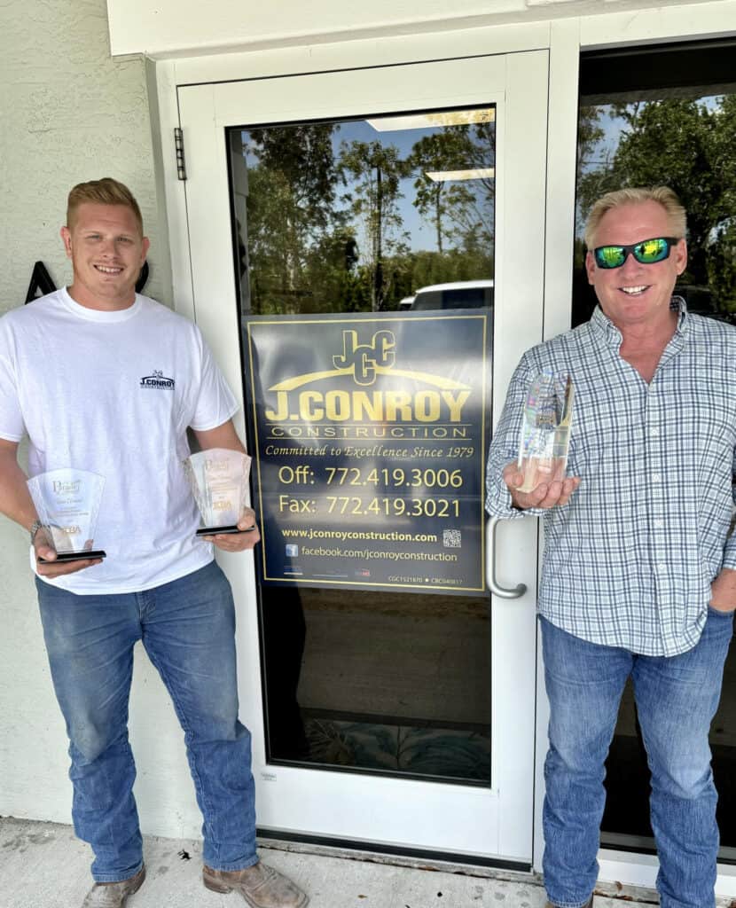Josh and Jim Conroy holding their 2024 Parade of Homes awards